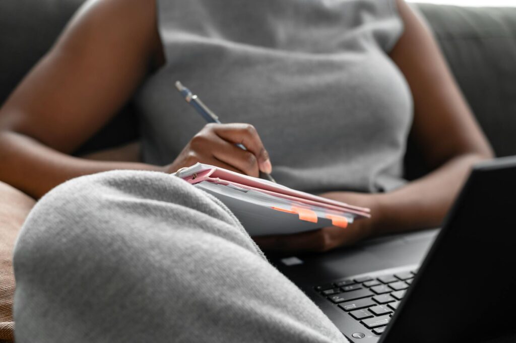 woman in gray tank top using macbook pro